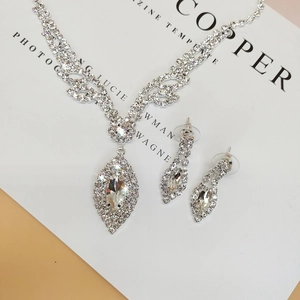 Detail of silver bridal necklace and earrings set with marquise stones for weddings
