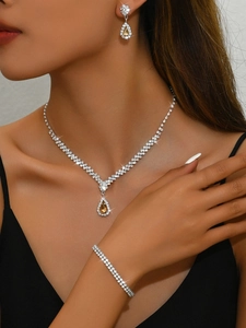 Detail of bridal jewelry set with yellow teardrop stones on model portrait