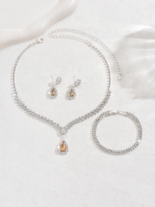 Detail of bridal jewelry set with pear-cut amber stones and silver pavé rhinestones