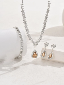 Macro detail of luxury bridal jewelry set with champagne zircons and white crystals