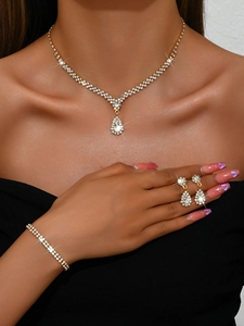 Close-up of gold rhinestone necklace and earrings set on model for bridal wedding