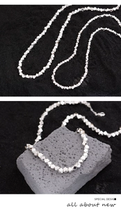 Detail of silver geometric faceted beads on a necklace with lobster clasp and chain