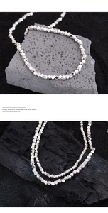 Macro detail of geometric faceted silver beads showing reflective metallic textures and light
