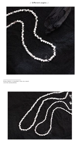 Detailed macro view of minimalist silver cube necklace with sharp metallic reflections