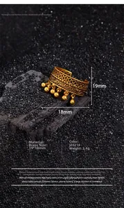 Detailed close-up of a vintage style brass ring featuring small bead tassels and lace texture