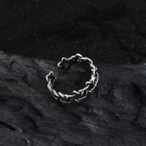 Retro hexagram open ring in antique silver with woven texture on a dark industrial background