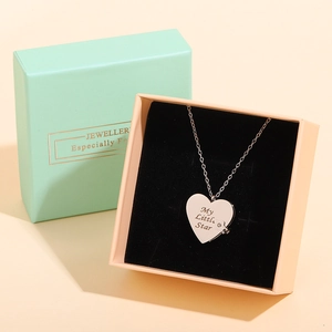 Detail of a heart pendant necklace engraved with My Little Star in a gift box