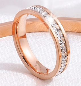 Vue macro d'une alliance en or rose sertie de pierres moissanites à la coupe carrée brillante