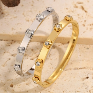 Detail of gold and silver plated stainless steel bracelets with flower and diamond design
