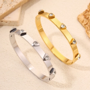 Detail of gold and silver plated titanium steel bangles with studded zircon crystals