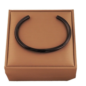 Minimalist matte black titanium steel Mobius open cuff bracelet for women shown on display