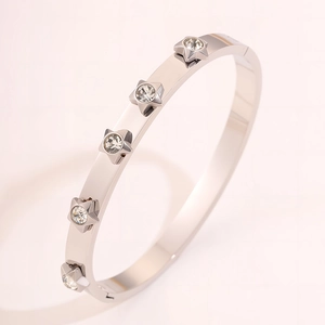 Detailed macro view of silver stainless steel bangle with five-pointed star zircon stones