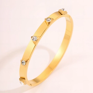 Detailed view of a gold-plated stainless steel cuff featuring five inlaid white zircons