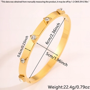 Polished gold stainless steel oval bangle featuring crystal inlay with detailed dimensions