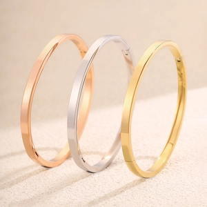 Drie minimalistische armbanden in roségoud, zilver en goudkleurig edelstaal