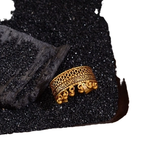 Vintage gold-tone open ring featuring hollow floral embossing and small bead tassels