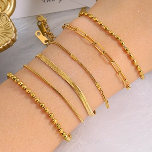 Close-up of a 6-piece gold stainless steel chain bracelet set featuring diverse link styles