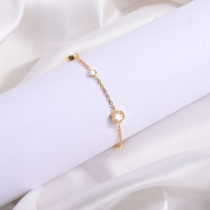 Detail of 18K gold-plated stainless steel bracelet with Roman numerals and zircons