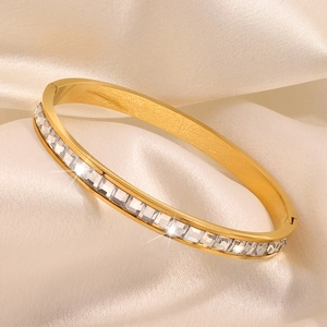 Detail of gold-plated stainless steel bangle with square-cut cubic zirconia inlays