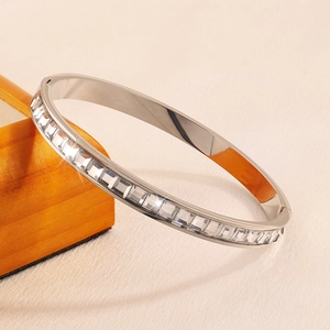 Close-up of silver stainless steel bangle featuring channel-set square-cut cubic zirconia stones