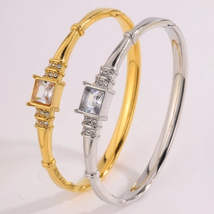 Macro shot of stainless steel bangles with large square zircon and side crystal accents