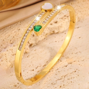 Detail of champagne gold heart bracelet featuring green gem, shell inlay and zircon pavé