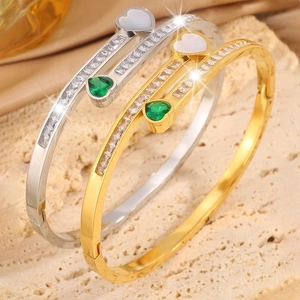 Luxurious gold and silver heart bracelets with sparkling zirconia and emerald accents
