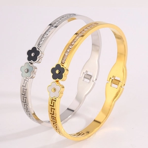 Titanium steel bangle with Greek meander pattern and dual enamel flowers