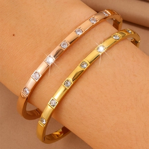 Close-up of rose gold and yellow gold titanium steel bracelets with seven crystals
