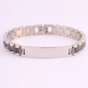 Detail of two-tone stainless steel watch band bracelet with polished blank bar centerpiece