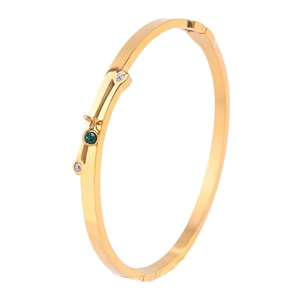 Polished gold titanium steel crossover bracelet with green emerald and sparkling zircons