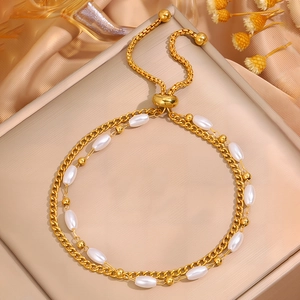 Double-layered gold stainless steel bracelet with white pearls and adjustable slider clasp