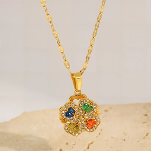 Macro shot of 18k gold plated rotating clover pendant with colorful crystal drop stones