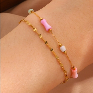 Double-layered gold stainless steel bracelet with pink bone-shaped beads for women