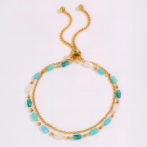 Detail of double-layer gold beaded bracelet featuring colorful beads and adjustable sliding clasp