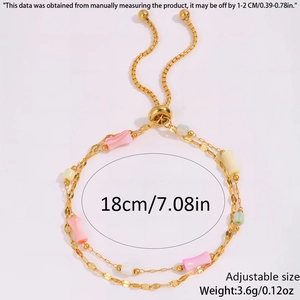 Detail showing adjustable gold-tone bamboo chain with colorful beads and sizing info