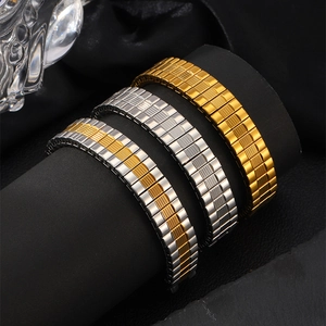 Detail of elastic stainless steel watch bands in gold, silver and two-tone finishes