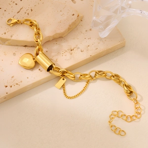 Detailed view of a gold-plated stainless steel thick chain bracelet with heart charm