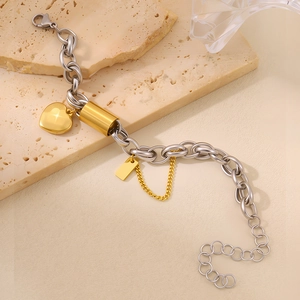 Detailed shot of mixed metal heart pendant bracelet with gold and silver links