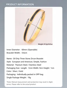 Detailed view of 18k gold plated stainless steel bangle with black enamel and three crystals