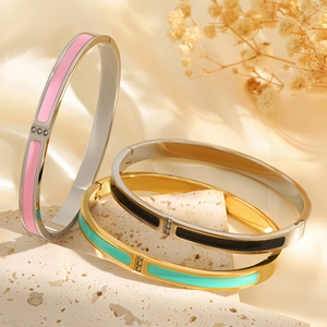 Polished stainless steel enamel bangles with three crystals in pink, black, and mint green