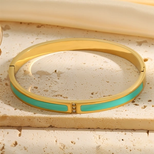 Detail of 18k gold plated bangle with turquoise enamel inlay and three small diamonds