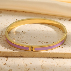 Close-up of 18k gold plated bangle featuring purple enamel finish and three inset diamonds