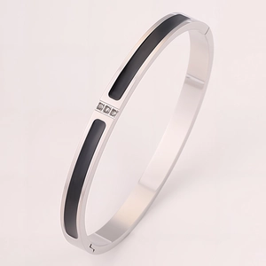 Detail showing silver stainless steel bangle with black enamel inlay and three zircons