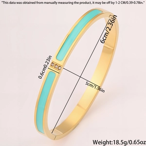 Detail showing 0.6cm wide 18k gold plated bangle with blue enamel and three zircons