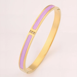 Detailed macro of a gold-plated stainless steel hinge bangle with purple enamel and diamonds