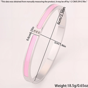 Detail view of pink enamel bangle with three cubic zirconia stones and dimensions