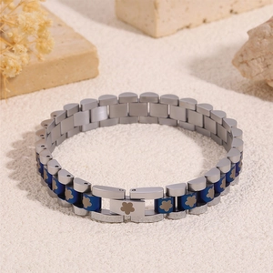 Detail of blue flower pattern on silver and blue stainless steel watchband style bracelet