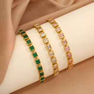 Close-up of zircon square gemstone bracelets in green, white and pink on gold chain