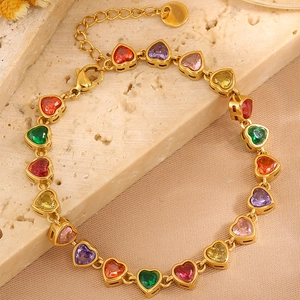 Detailed view of the gold heart-shaped bracelet with multi-colored gemstones and extension chain